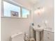 Bright bathroom with pedestal sink, toilet and storage cabinet at 700 16Th Nw St, Largo, FL 33770