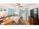 Bright bedroom with windows, ceiling fan, and dresser at 700 16Th Nw St, Largo, FL 33770