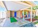 Open carport with a cozy seating area, blending convenience with welcoming outdoor charm at 700 16Th Nw St, Largo, FL 33770