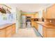 Open kitchen with stainless steel appliances, light wood cabinets, and tile floor at 700 16Th Nw St, Largo, FL 33770