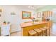 View of the kitchen bar, decor, lighting and cabinet space at 700 16Th Nw St, Largo, FL 33770