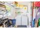 Functional laundry room with washer, dryer, water heater, and practical storage solutions for efficient household tasks at 700 16Th Nw St, Largo, FL 33770