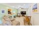 Cozy living room with neutral colors, comfortable seating, and access to the kitchen at 700 16Th Nw St, Largo, FL 33770