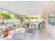 Charming covered patio with brick flooring, ideal for outdoor relaxation and dining in a private backyard setting at 700 16Th Nw St, Largo, FL 33770