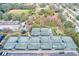 An aerial view highlights multiple tennis courts, perfect for sports enthusiasts and community gatherings in a landscaped setting at 700 16Th Nw St, Largo, FL 33770