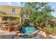 Landscaped backyard with custom spa, stone waterfall, and manicured garden beds at 701 S Boulevard, Tampa, FL 33606