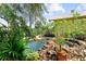 Picturesque backyard features a lush landscape, a pool, and a waterfall feature at 701 S Boulevard, Tampa, FL 33606