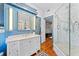 Bathroom with stylish vanities, marble walk-in shower, and wood floors at 701 S Boulevard, Tampa, FL 33606