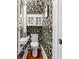 Charming powder room with floral wallpaper, unique sink, and elegant fixtures at 701 S Boulevard, Tampa, FL 33606