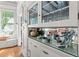 Dining room features built-in hutch with glass doors, drawers, hardwood floors and stain glass window at 701 S Boulevard, Tampa, FL 33606
