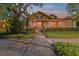 Charming home with a well-manicured lawn, inviting front porch, and mature trees in a desirable neighborhood at 701 S Boulevard, Tampa, FL 33606
