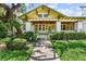Inviting home featuring mature landscaping and a covered front porch with ceiling fans at 701 S Boulevard, Tampa, FL 33606