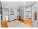 Bright hallway with wooden floors, storage closet, and view into blue accent bathroom at 701 S Boulevard, Tampa, FL 33606