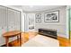 Hallway with wood floors, decorative chest, and a glimpse into the bedroom at 701 S Boulevard, Tampa, FL 33606