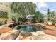 Inviting stone hot tub with mature landscaping in a private backyard setting at 701 S Boulevard, Tampa, FL 33606