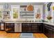 Kitchen features hardwood floors, granite countertops, stainless steel appliances, custom cabinetry, and a sink at 701 S Boulevard, Tampa, FL 33606