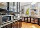 Kitchen features stainless steel appliances, hardwood floors, custom cabinetry and granite countertops at 701 S Boulevard, Tampa, FL 33606