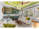 Bright living room with built-in cabinets, light green ceiling, and comfortable seating arrangement at 701 S Boulevard, Tampa, FL 33606