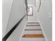 Staircase with hardwood treads and painted risers leading upstairs at 701 S Boulevard, Tampa, FL 33606