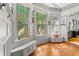 Bright sunroom with hardwood floors, decorative windows, and built-in seating at 701 S Boulevard, Tampa, FL 33606