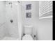 Bathroom featuring a stand-up shower with marble tile and nautical decor at 7202 8Th N Ave, St Petersburg, FL 33710