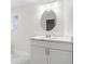 Bright bathroom with modern vanity, sleek countertop, round mirror, and stylish fixtures at 7202 8Th N Ave, St Petersburg, FL 33710