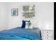 Bright bedroom featuring stylish nautical decor, cozy blue bedding, and a side table at 7202 8Th N Ave, St Petersburg, FL 33710