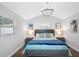 Serene bedroom with vaulted ceiling, a chandelier, neutral decor, and wood floors at 7202 8Th N Ave, St Petersburg, FL 33710