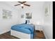 Serene bedroom featuring a ceiling fan, a cozy bed with blue accents, and natural light from nearby windows at 7202 8Th N Ave, St Petersburg, FL 33710