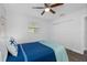Well-lit bedroom with a ceiling fan, spacious closet, and comfortable-looking bed at 7202 8Th N Ave, St Petersburg, FL 33710