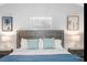 Bright bedroom featuring a wooden headboard, blue accents and beach-themed wall art for a serene atmosphere at 7202 8Th N Ave, St Petersburg, FL 33710