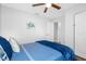 Cozy bedroom with a ceiling fan, coastal-themed decor, and a view into the ensuite bathroom at 7202 8Th N Ave, St Petersburg, FL 33710