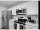 A modern kitchen featuring stainless steel appliances, white cabinets, and a bright, airy layout at 7202 8Th N Ave, St Petersburg, FL 33710