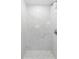 Modern shower featuring marble-look tile walls and a mosaic tile shower floor at 7202 8Th N Ave, St Petersburg, FL 33710