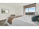 Bright bedroom featuring a sliding glass door, waterfront views, and neutral decor at 7645 Sun Island S Dr # 204, South Pasadena, FL 33707