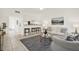 Bright living room featuring a neutral color palette, bar-style seating, and tile flooring at 7645 Sun Island S Dr # 204, South Pasadena, FL 33707