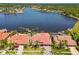 Waterfront home with red tile roof, well-manicured lawn, and a backyard swimming pool at 9807 Bay Island Dr, Tampa, FL 33615