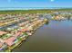 Waterfront houses with private boat docks, red tile roofs, and lush landscaping at 9807 Bay Island Dr, Tampa, FL 33615
