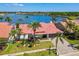 Aerial shot of a waterfront house with a red tile roof, lush landscaping, and access to a serene bay at 9807 Bay Island Dr, Tampa, FL 33615