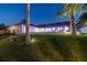 Backyard view of the house at night, featuring a covered patio and lawn at 9807 Bay Island Dr, Tampa, FL 33615