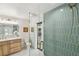 Elegant bathroom features a modern vanity, stylish mirror, and a shower with designer tile at 9807 Bay Island Dr, Tampa, FL 33615