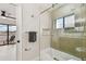 Clean bathroom featuring updated shower with glass door, storage niche, and outdoor balcony access at 9807 Bay Island Dr, Tampa, FL 33615
