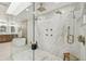 Stunning bathroom featuring a large walk-in shower, soaking tub, and dual vanity with lighted mirrors at 9807 Bay Island Dr, Tampa, FL 33615