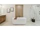 Modern bathroom featuring a freestanding tub and a glass-enclosed shower with marble surround at 9807 Bay Island Dr, Tampa, FL 33615