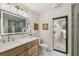 Stylish bathroom with a marble countertop vanity, modern lighting, and a view of the outdoor patio at 9807 Bay Island Dr, Tampa, FL 33615