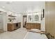 Spacious bathroom featuring dual vanities, a soaking tub, and a bar area with a wine refrigerator at 9807 Bay Island Dr, Tampa, FL 33615