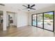 Bright bedroom with wood floors, ceiling fan, and large sliding glass doors to the outdoor pool area at 9807 Bay Island Dr, Tampa, FL 33615