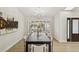 Chic dining room with long, dark wood table, seating for eight, and stylish chandelier at 9807 Bay Island Dr, Tampa, FL 33615