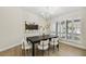 Bright dining room features wood floors, modern chandelier, and plantation shutters allowing natural light at 9807 Bay Island Dr, Tampa, FL 33615
