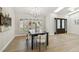 Dining room featuring wood floors, modern chandelier, and stylish decor with ample natural light at 9807 Bay Island Dr, Tampa, FL 33615